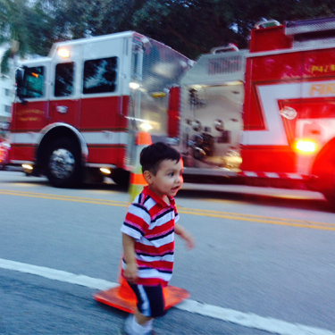 Toddler in front of a fire truck